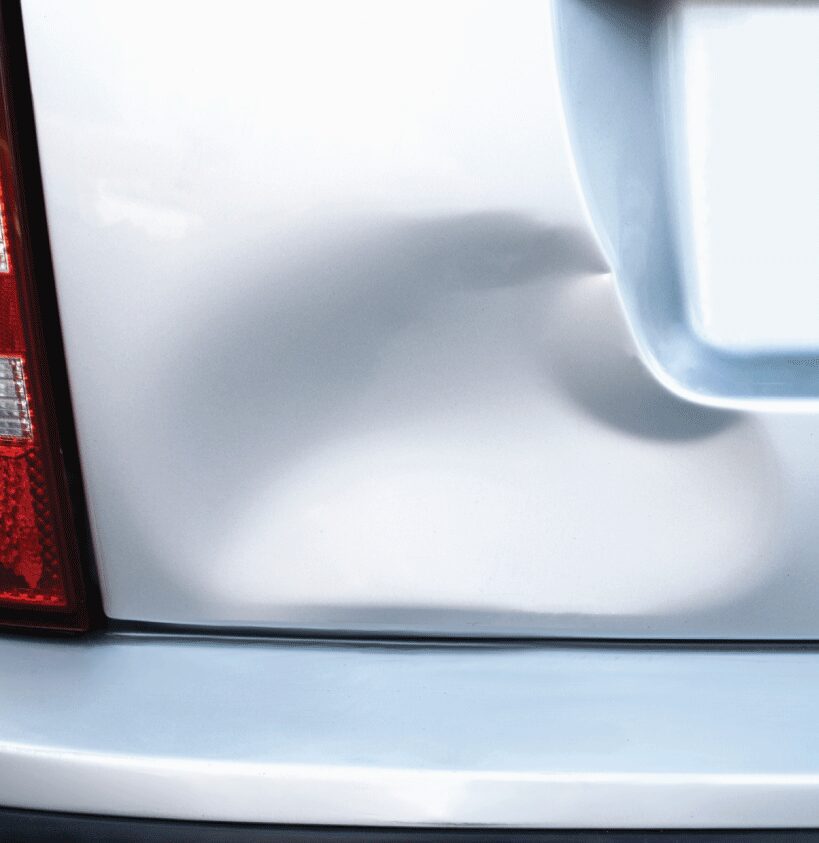 1/2 of part of a sliding image showing a huge dent in the boot in USA